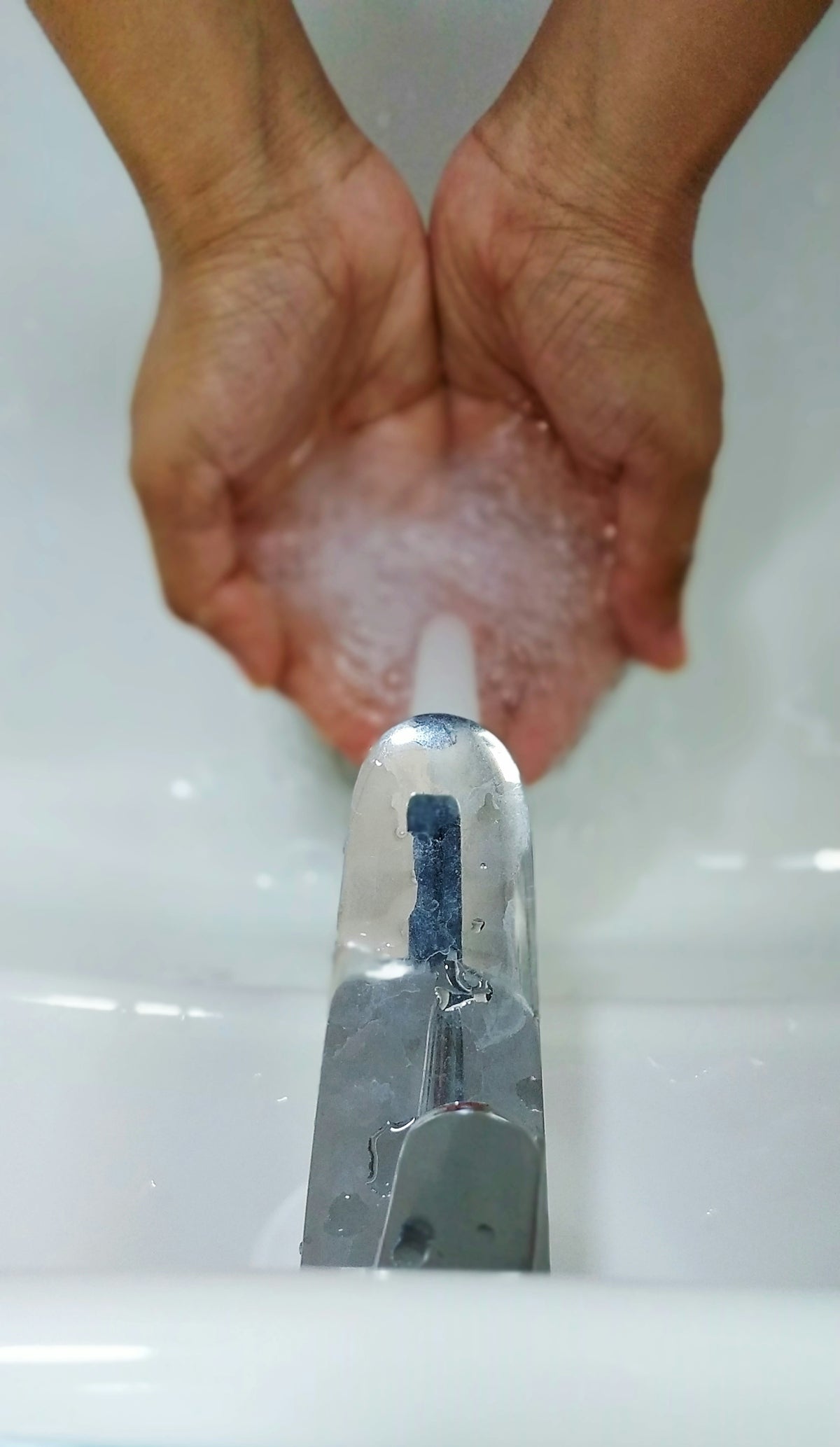 person holding silver steel bar