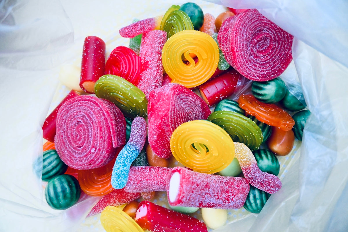 a pile of colorful candy sitting on top of a white table