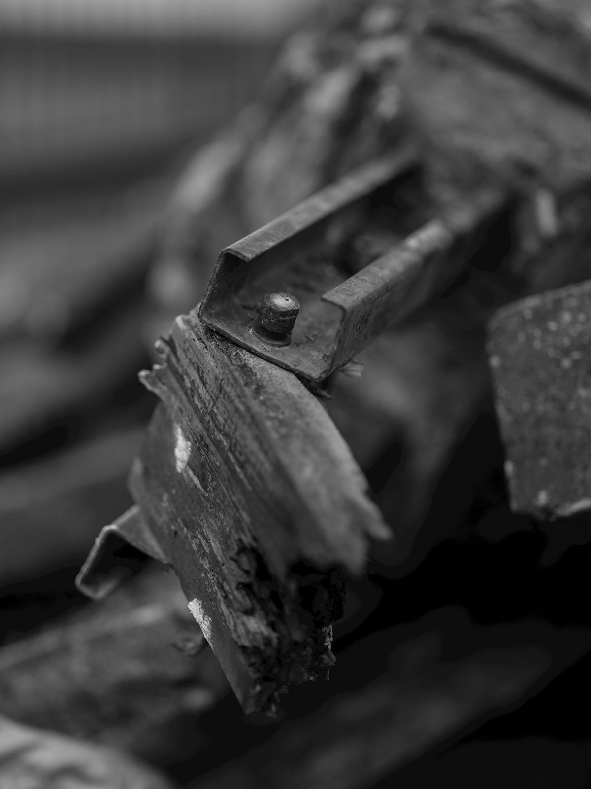 Old, broken metal parts in black and white.